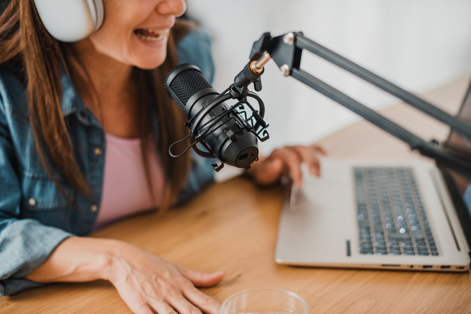 Woman in headphones recording podcast